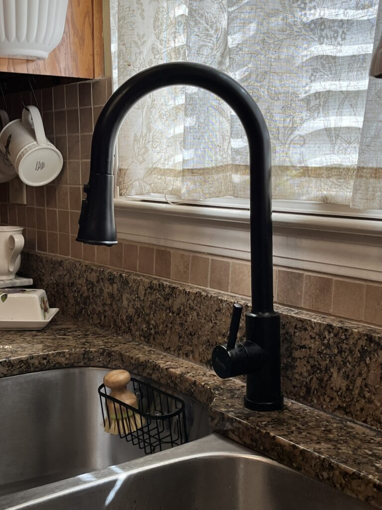 Matte black faucet compliments the countertops nicely.